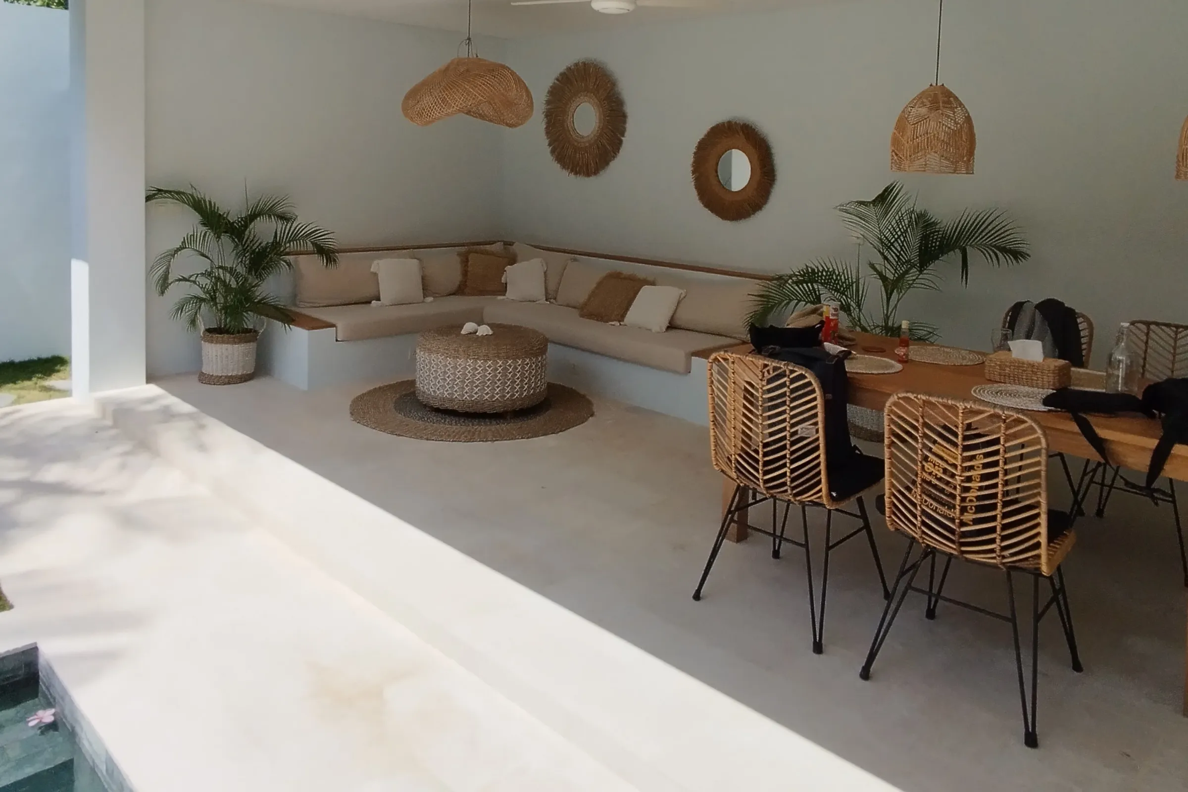 Outdoor living space design in Los Angeles with covered patio lounge, modern seating, and clean architectural finish