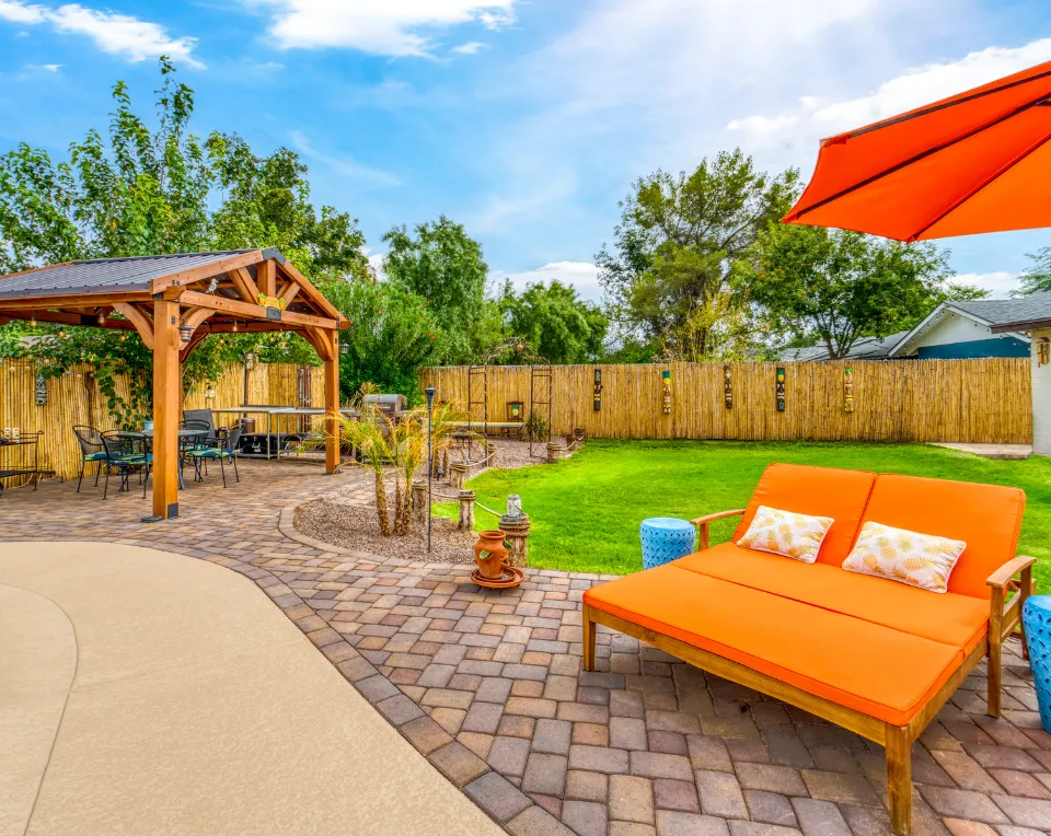 Backyard patio after construction in Los Angeles with pavers, pergola, and outdoor seating area