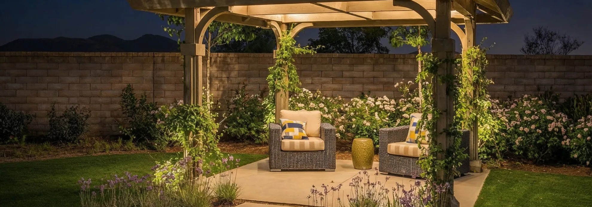 Pergola patio cover in Los Angeles at night with warm lighting, wood beams, and cozy outdoor seating area