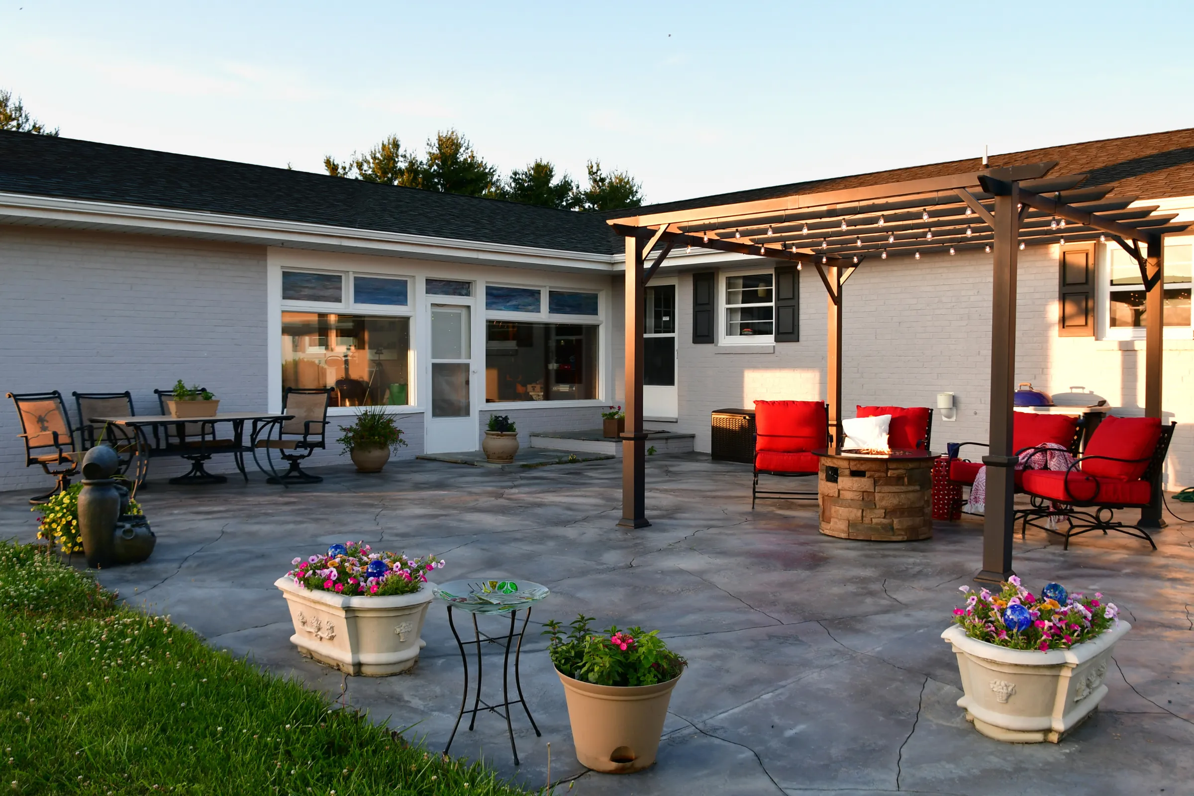 Backyard patio construction in Los Angeles featuring a wood deck with shade sail and outdoor seating area